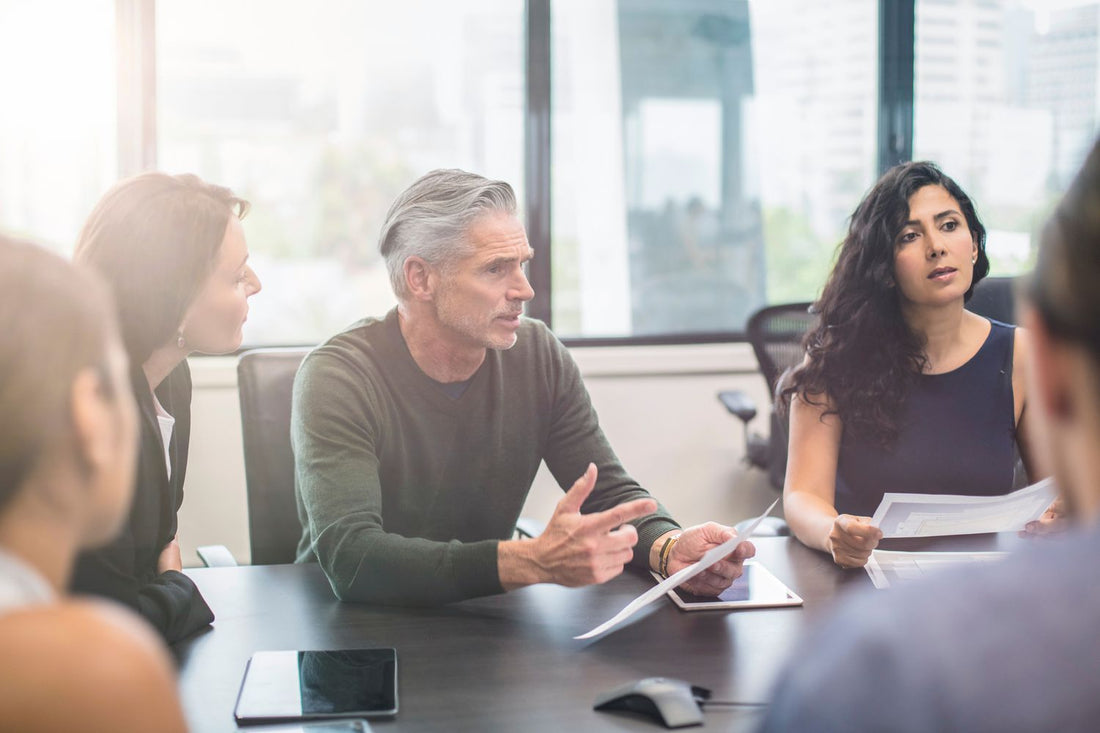 Advisers working with a leadership team in a boardroom